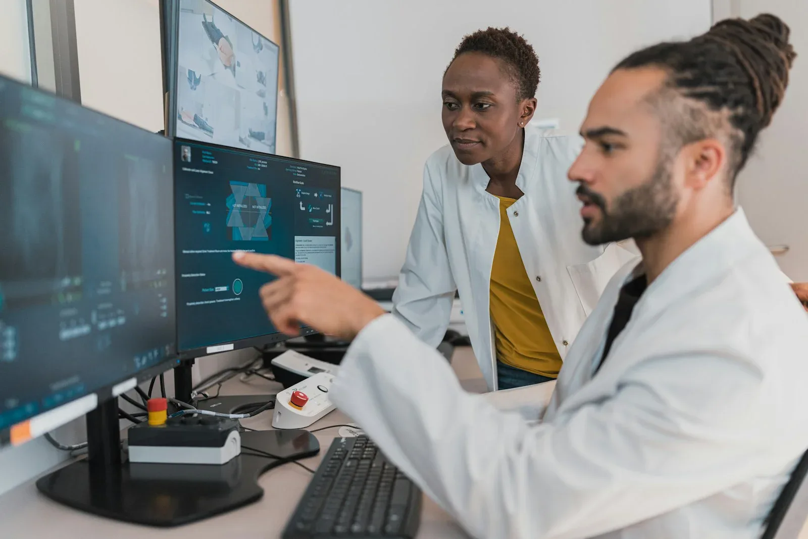 Medical professionals reviewing images at a clinical imaging workstation